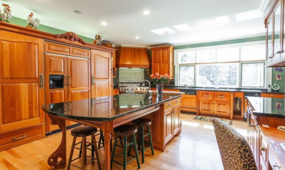 Example of a big and expansive kitchen with wood furnishings
