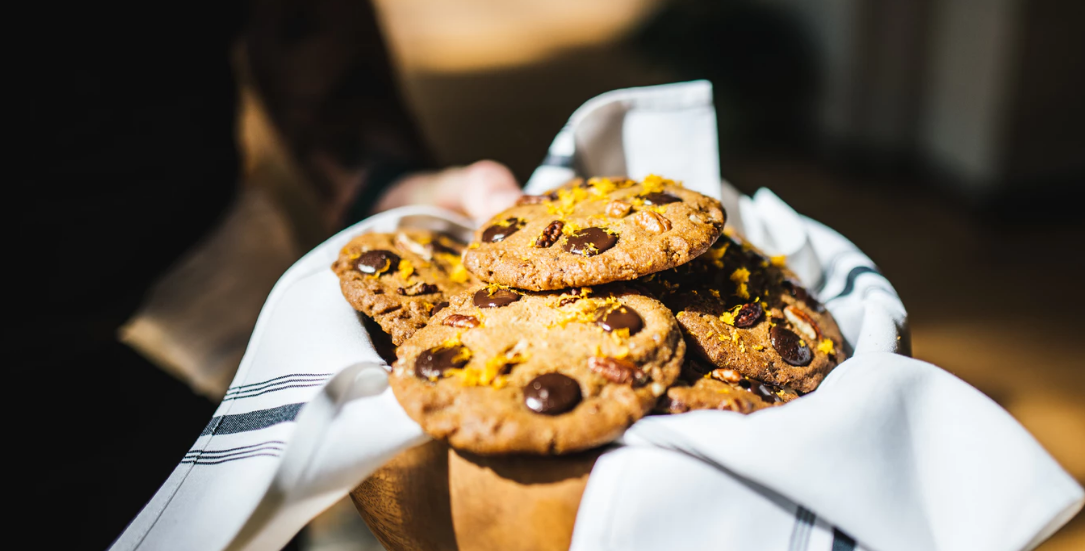 Person serving a box of cookies